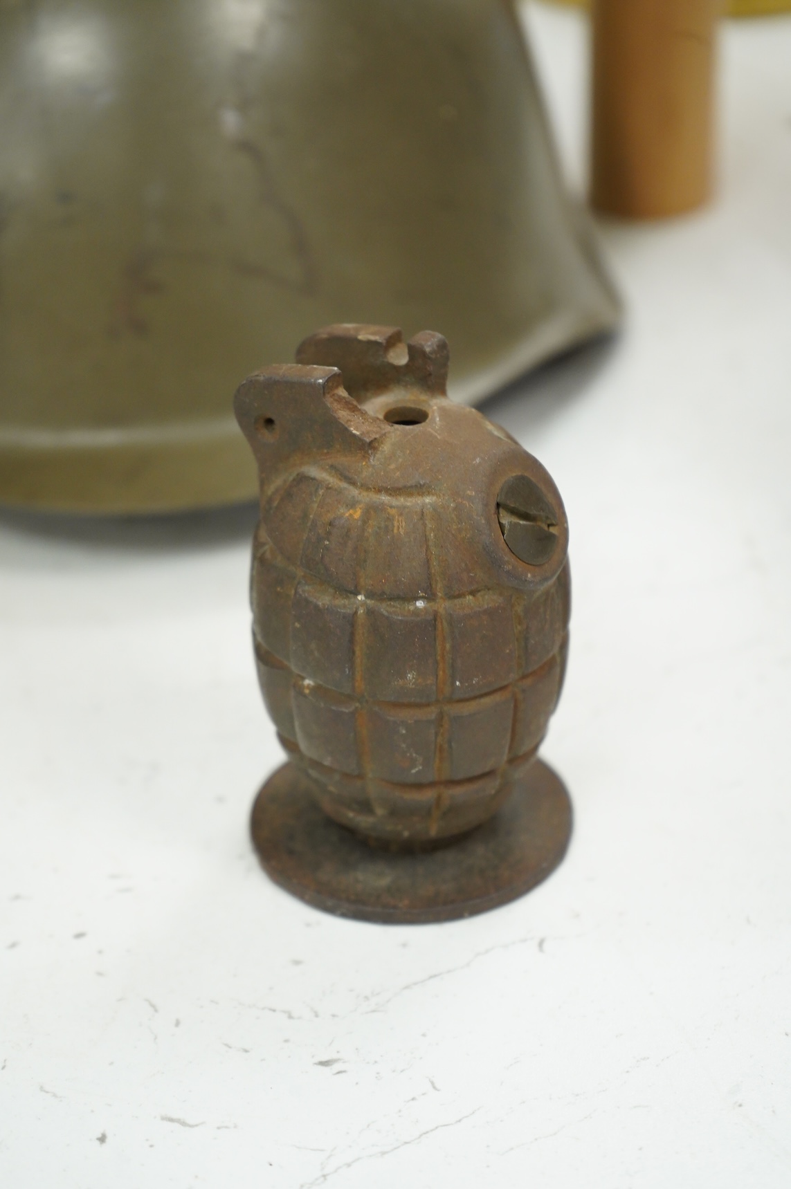 A Czech Vz53 tin helmet with liner, a Kris with applied presentation plaque engraved with ‘Presented by 'C' Battery’ and an inert British Mills hand grenade